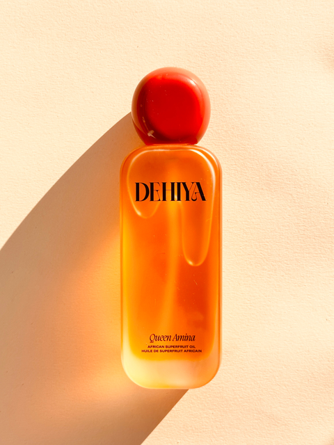 DEHIYA Queen Amina, orange colored oil, red cap flat lay